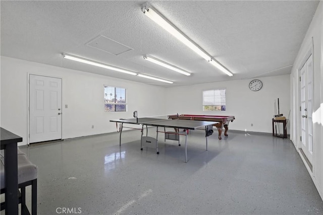 rec room featuring a textured ceiling