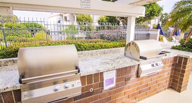 view of patio with an outdoor kitchen and grilling area