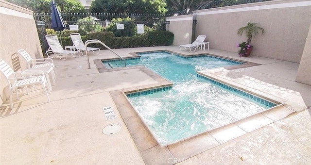 view of swimming pool with a patio