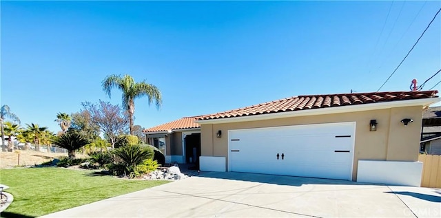 mediterranean / spanish-style house with a garage and a front lawn