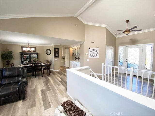 22761 Granite Dome Pl, Canyon Lake, CA 92587 - hallway with an inviting chandelier, ornamental molding, high vaulted ceiling, and light hardwood / wood-style flooring