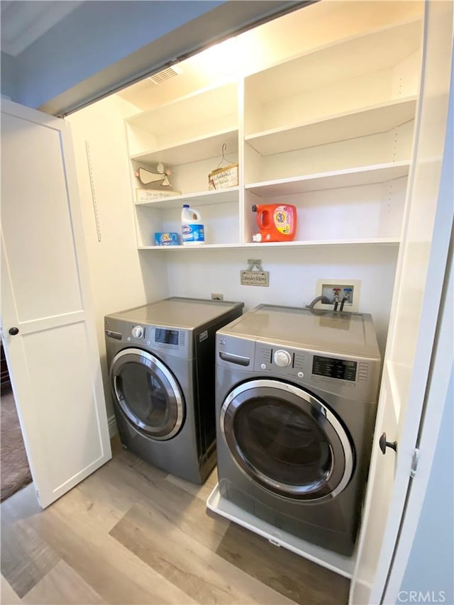 22761 Granite Dome Pl, Canyon Lake, CA 92587 - washroom featuring separate washer and dryer and light hardwood / wood-style floors