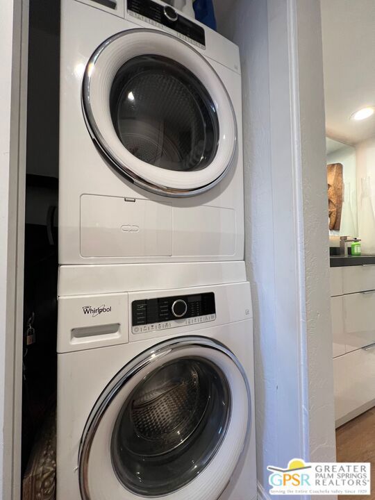 laundry area with stacked washer / dryer