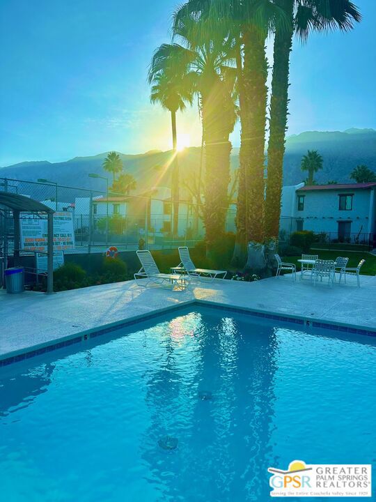 view of swimming pool with a mountain view and a patio area