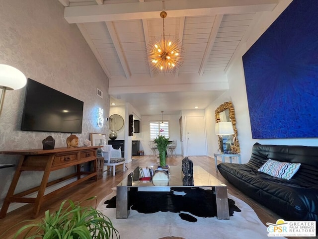 living room with an inviting chandelier, beam ceiling, and hardwood / wood-style floors