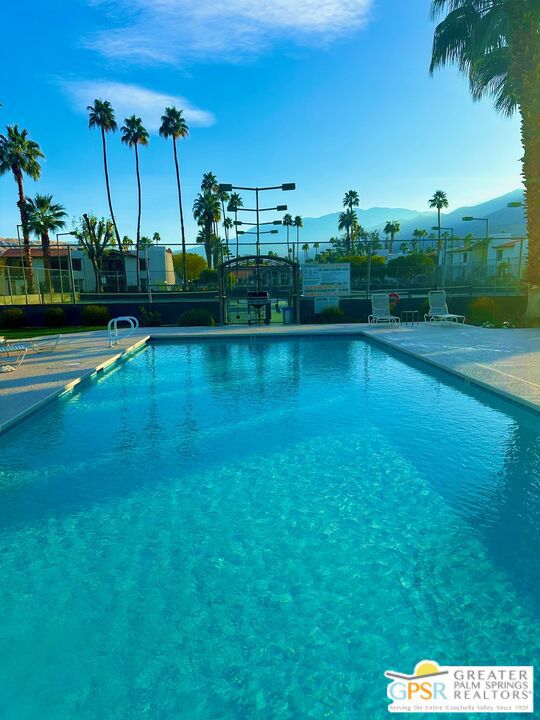 view of swimming pool featuring a mountain view and a patio area