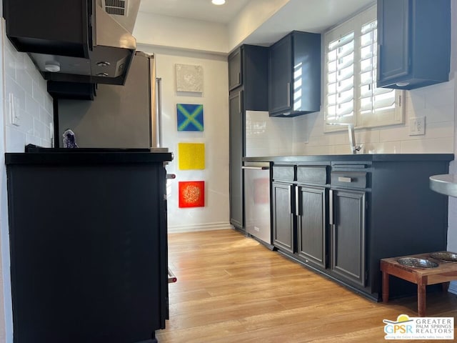 kitchen featuring blue cabinets, ventilation hood, light wood-type flooring, dishwasher, and backsplash