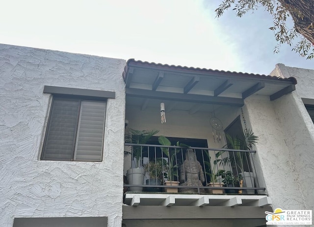 view of side of home featuring a balcony