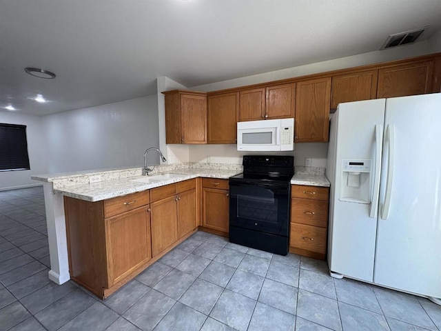 kitchen featuring sink, light tile patterned floors, light stone counters, kitchen peninsula, and white appliances