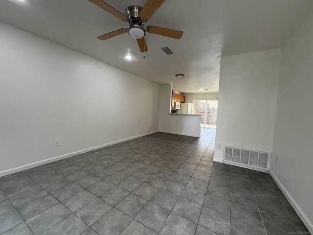 spare room with tile patterned floors and ceiling fan