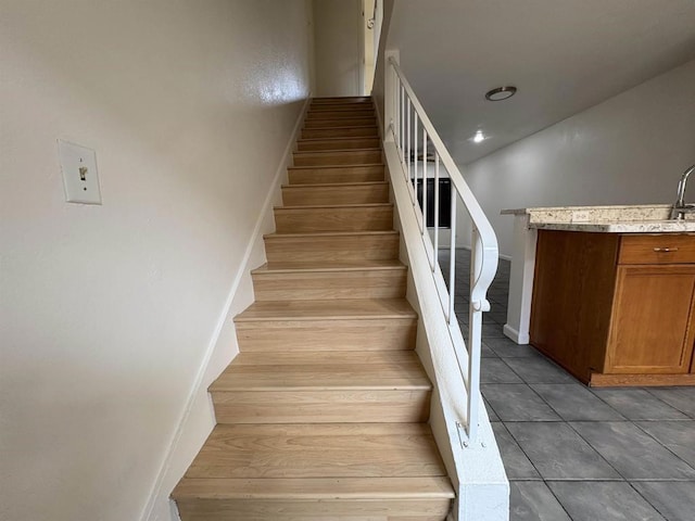 stairway with tile patterned floors