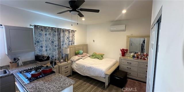 bedroom featuring dark hardwood / wood-style flooring, ceiling fan, and a wall mounted AC