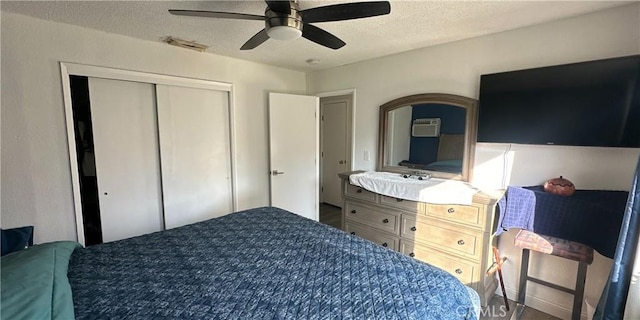 bedroom with ceiling fan, a closet, and a textured ceiling