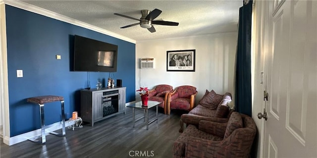 living room featuring dark wood-type flooring, a wall mounted AC, a textured ceiling, ornamental molding, and ceiling fan