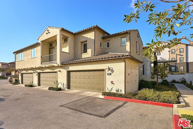 mediterranean / spanish home featuring a garage