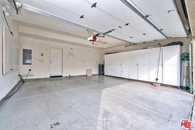 garage featuring a garage door opener and electric panel