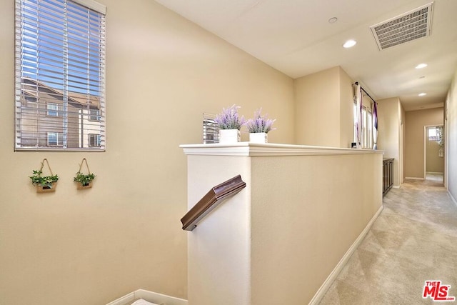 hallway with light colored carpet