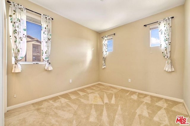 spare room with light colored carpet