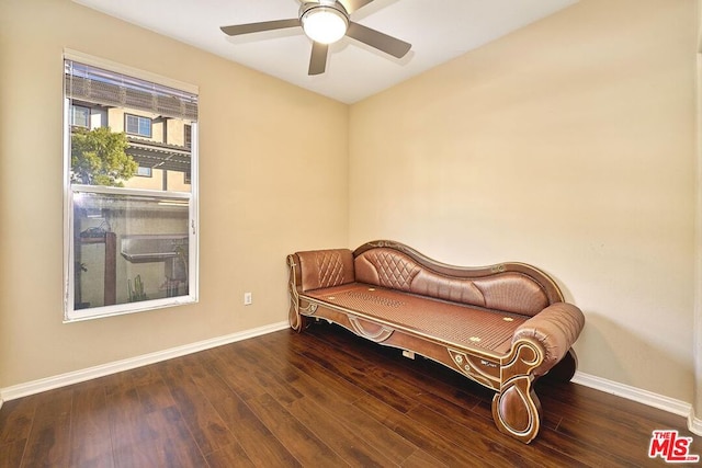 living area with ceiling fan and dark hardwood / wood-style flooring