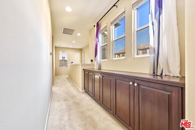 hallway with light colored carpet