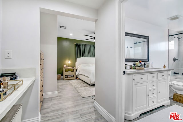 full bathroom with ceiling fan, vanity, toilet, and bathing tub / shower combination