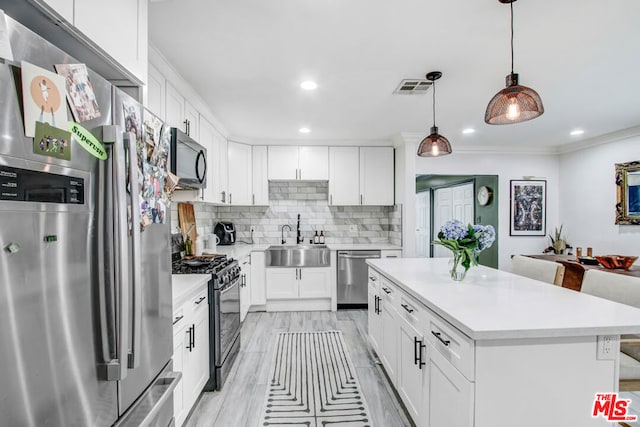 kitchen with stainless steel appliances, white cabinetry, and sink