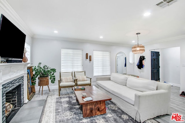 living room featuring crown molding, a high end fireplace, and light hardwood / wood-style flooring