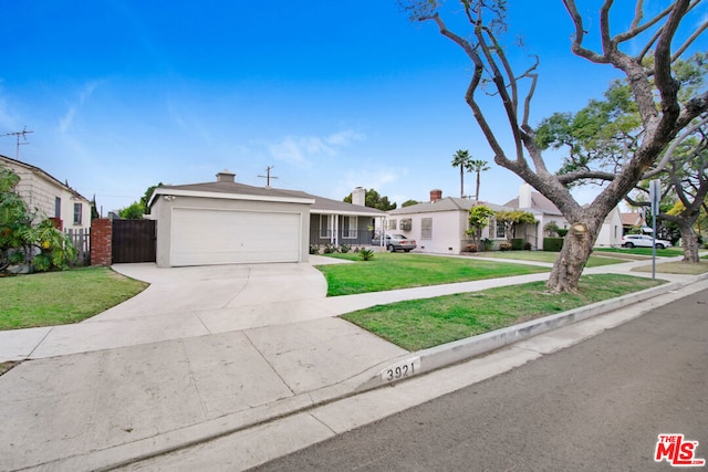 single story home featuring a garage and a front yard