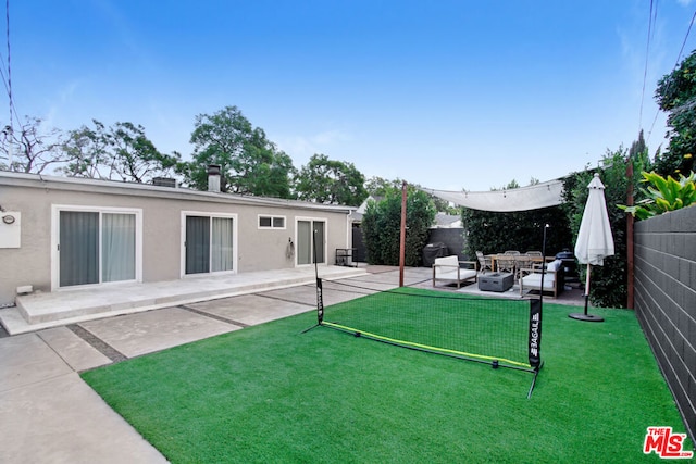 view of yard with an outdoor living space and a patio