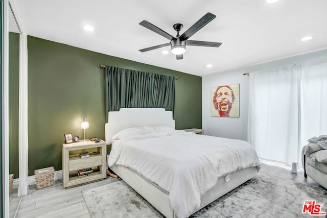 bedroom featuring hardwood / wood-style floors and ceiling fan