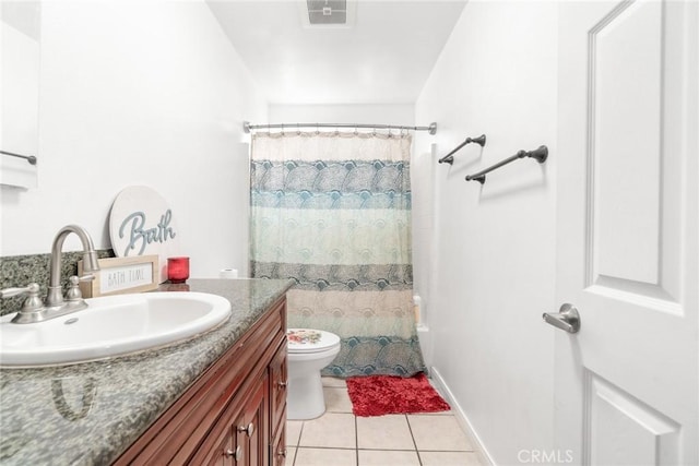 bathroom featuring tile patterned flooring, vanity, and toilet