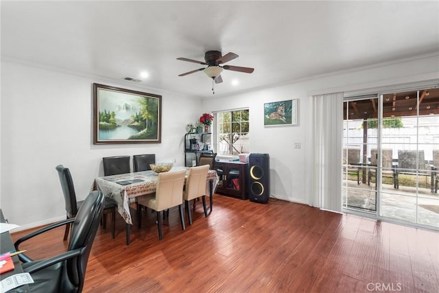 dining space featuring crown molding, dark hardwood / wood-style floors, and ceiling fan