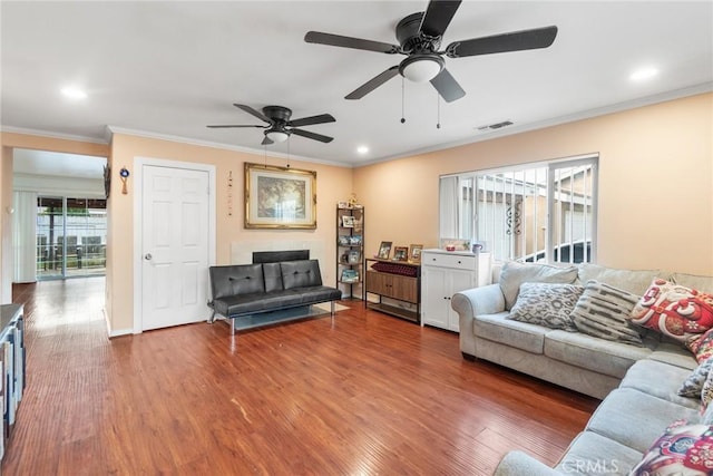 living room featuring crown molding, ceiling fan, and dark hardwood / wood-style floors