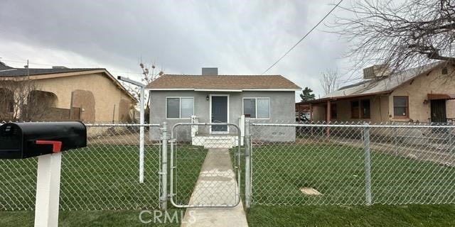 bungalow-style home with a front lawn