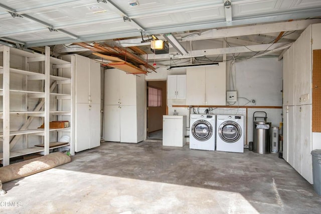 garage with a garage door opener and washing machine and clothes dryer