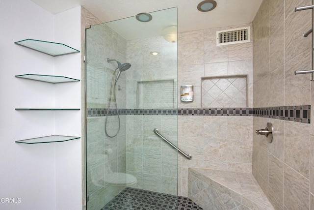 bathroom featuring tiled shower