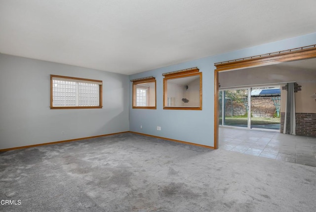 carpeted empty room with plenty of natural light