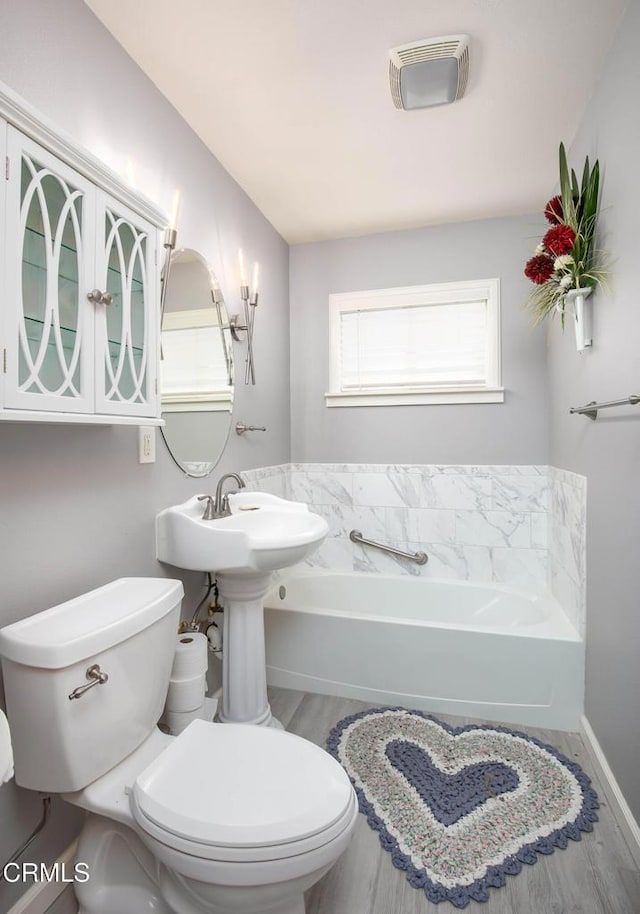 bathroom featuring a bathtub and toilet