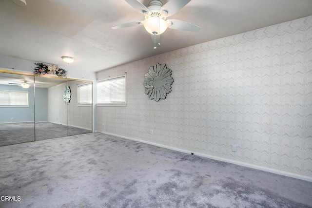 unfurnished bedroom with carpet floors, ceiling fan, and a closet