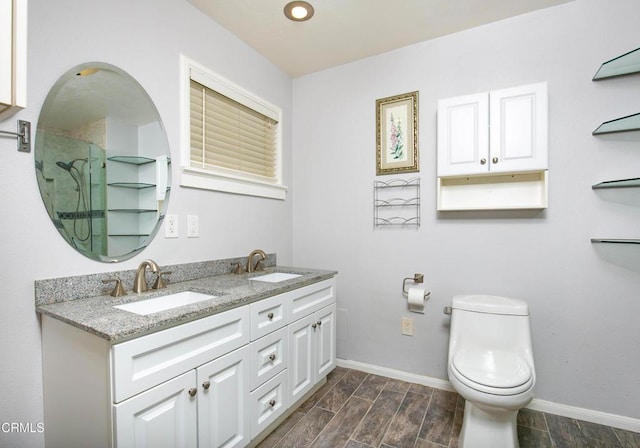 bathroom with vanity, toilet, and an enclosed shower