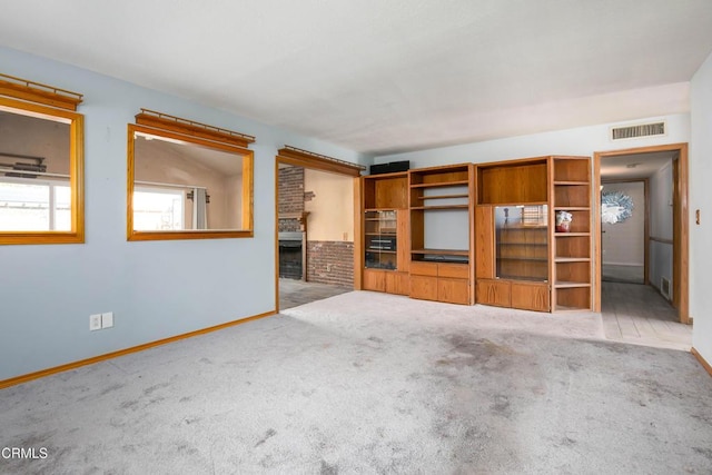 unfurnished living room with a fireplace and light carpet