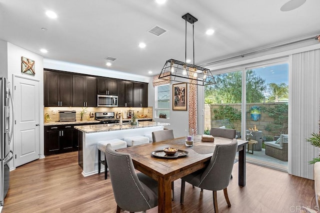 dining space featuring light wood-type flooring