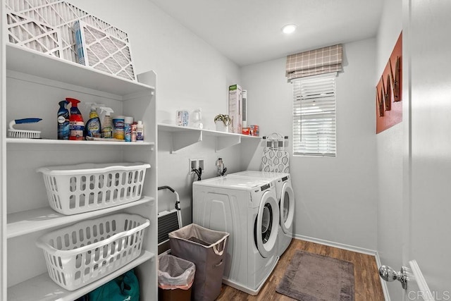 clothes washing area featuring hardwood / wood-style flooring and washing machine and clothes dryer