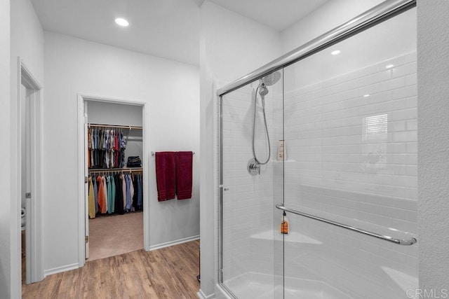 bathroom featuring hardwood / wood-style floors and a shower with shower door