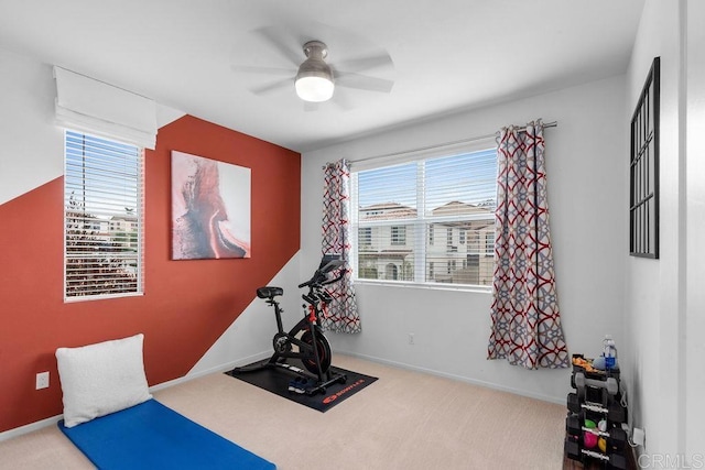 exercise room featuring ceiling fan and light carpet