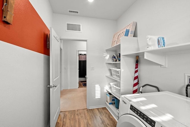 laundry room featuring washer / clothes dryer and light hardwood / wood-style floors