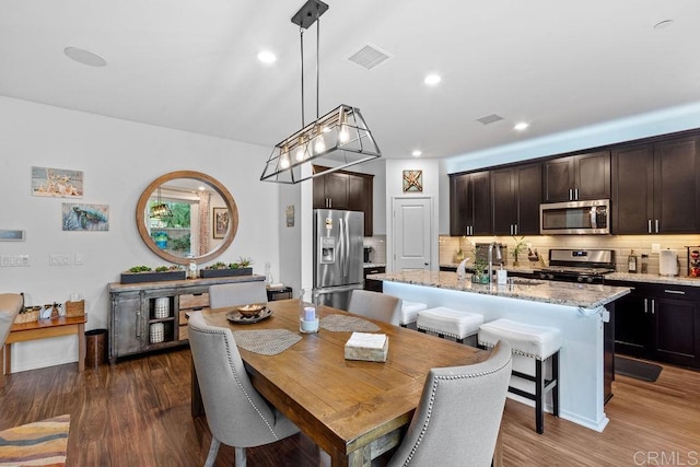 dining area featuring dark wood-type flooring and sink