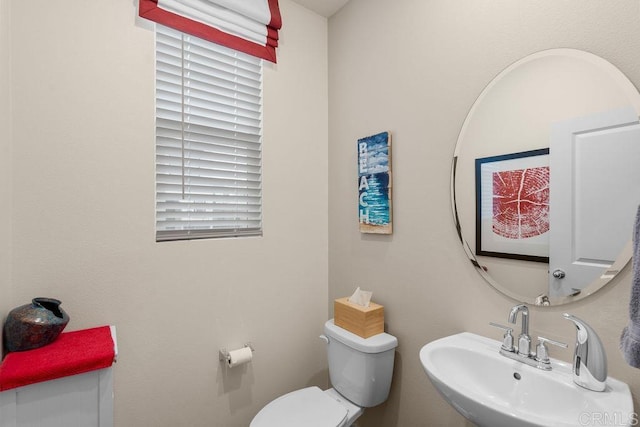 bathroom featuring sink and toilet