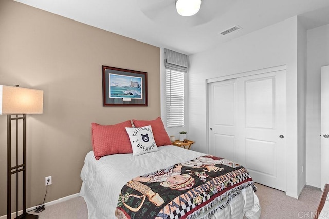 bedroom with light carpet, baseboards, visible vents, a ceiling fan, and a closet