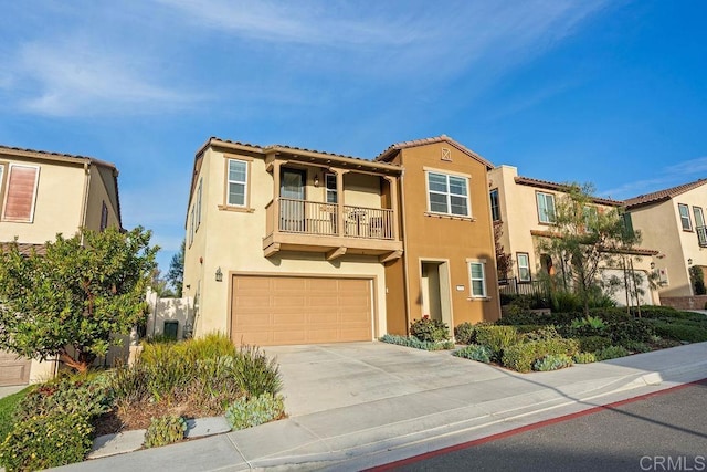 view of front of property with a garage, concrete driveway, a balcony, and stucco siding